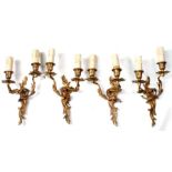 A set of four gilt metal rococco style two-branch wall lights (4).
