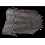 An early 20th century silver (tested) chain mesh drawstring evening bag with hanging ball