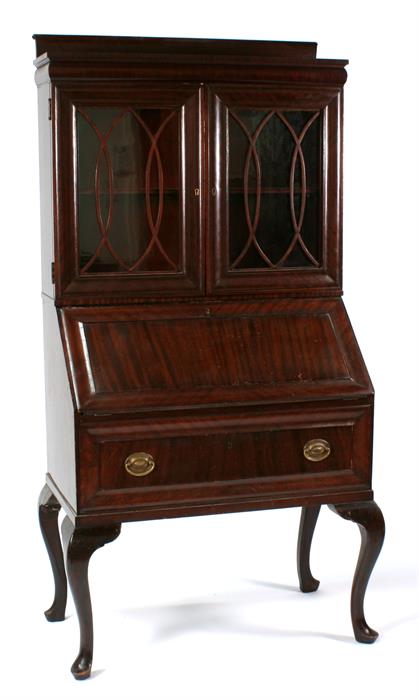 A mahogany bureau bookcase, the pair of glazed doors enclosing a shelved interior, above a fall