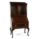 A mahogany bureau bookcase, the pair of glazed doors enclosing a shelved interior, above a fall