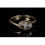 A three stone diamond ring, approx UK size P.