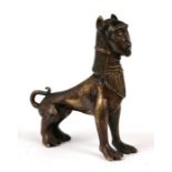 A Persian or Eastern bronze figure of a Sphinx, 20cms (8ins) high.