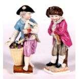 A pair of Sitzendorf figures in the form of young boys wearing 18th century dress, 15cm (6ins) high