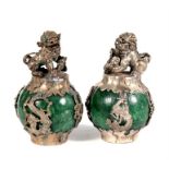 A pair of white metal and stone scroll weights, surmounted with a shi shi, 7cms (3.75ins) high (2).