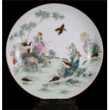 A large Chinese famille rose charger, decorated with quail amongst flowers, with six character red