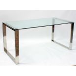 A modern design glass and polished steel rectangular topped table or desk, 160cms (63ins) wide.