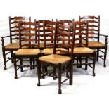A set of eight oak ladder back chairs including two carvers, on turned front supports with rush