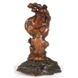 A Chinese root wood carving, depicting a bearded man carrying a branch of fruit, 27cm (10.5ins) high