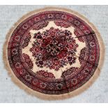 A machine made Belgium silk effect circular rug with central medallion within a foliate border on