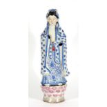 A Chinese figure of Guan Yin with impressed mark to the underside 42cm (16.5ins) high Condition