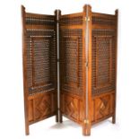 A Middle Eastern three-fold wooden screen with turned spindle decoration, 205cm (80.75ins) wide.