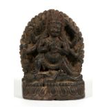 An Indian carved hardwood figure in the form of a multi-armed deity, 12.5cms (5ins) high.