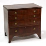 A 19th century mahogany chest of small proportions, with four long graduated drawers, on splayed