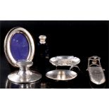A silver capstan inkwell; a silver spectacle case; a silver topped scent bottle; and other silver