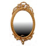 A Victorian gilt framed oval mirror, 93cms (36.5ins) high.