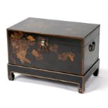 A chinoiserie box on stand, decorated with birds and fruit on a black ground, 66cms (26ins) wide.