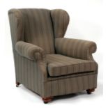 An Edwardian armchair, on turned front supports.