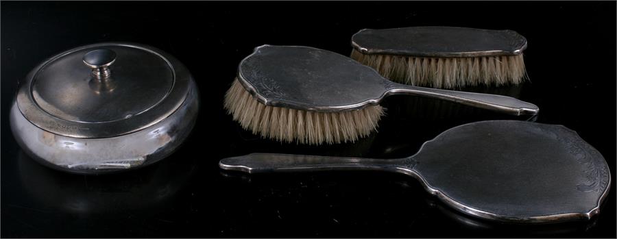 A silver mirror and two brush set with large silver lidded and mounted powder bowl.