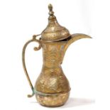 A large Turkish or Islamic brass dallah coffee pot, 54csm (21.25ins) high.