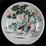 A Chinese famille verte shallow dish, decorated with figures under a tree, 29.5cms (11.5ins)