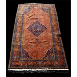 An Ardebil woollen hand made rug with central medallion and stylised borders, on navy ground, 285 by