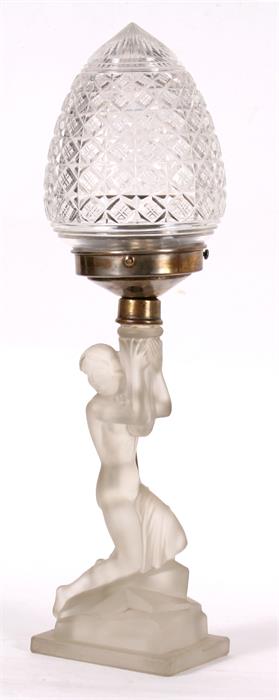 An Art Deco frosted glass table lamp in the form of a naked lady, 42cms (16.5ins) high.