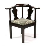 A 19th century mahogany corner chair with drop-in seat, on square chamfored legs.
