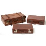 Three vintage suitcases.