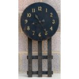 An early 20th century 'Mission Style' oak wall clock, 80cms (31.5ins) high.
