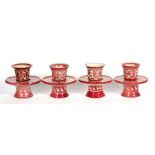 A set of four 1890's Emile Balon, faience de Blois ruby lustre cups on stands, 11.5cms (4.25ins)