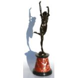 An Art Deco style bronze figure in the form of a dancing girl, mounted on a black slate & figured