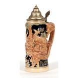 A German pottery stein decorated with deer, the handle modelled as a fox.