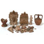A quantity of antiquities including a Roman figure, Roman and medieval pottery shards and two