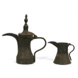 A Turkish / Islamic brass dallah coffee pot and brass jug, the dallah 23cms (9ins) high, the jug