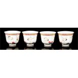 A set of four Chinese tea bowls decorated with cranes in flight and having a six character red