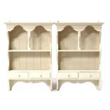 A pair of painted pine wall shelves, 60cms (23.75ins) wide (2).