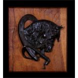 A bronze plaque depicting a horses head with riding crop, mounted on an oak board, 27 by 30cms (10.5