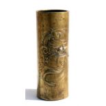 A Chinese brass brush pot, decorated in relief with a dragon amongst clouds, with two character mark
