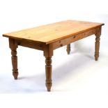 A modern pine rectangular topped kitchen table on turned legs, 183cms (72ins) long.