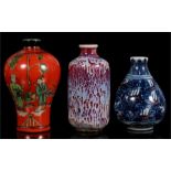 Three Chinese porcelain snuff bottles, the largest 7cms (2.75ins) high.