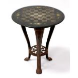 A painted slate games table on cast iron tripod base, 51cms (20ins) diameter