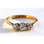 An 18ct gold three-stone diamond ring, UK size 'L'. Condition Report Weight 2.1g overall.