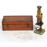 A late 19th / early 20th century lacquered brass students microscope in original box, 15.5cms (6ins)