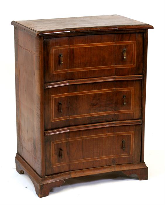 A continental walnut chest of three concave long drawers, standing on bracket feet, 62cms (24.
