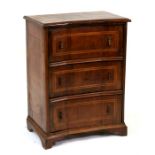 A continental walnut chest of three concave long drawers, standing on bracket feet, 62cms (24.