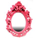 A modern decorative pink velour framed wall mirror, 64cms (25ns) high.