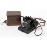 A black Bakelite field telephone.