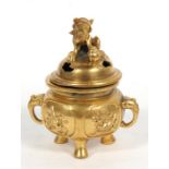 A Chinese gilded bronze two-handled censer decorated with birds and fo dog finial, elephant