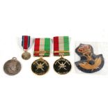 Two mounted Omani General Service Medals by Spink with other Omani medals and an officers cap badge
