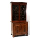 A 19th century mahogany glazed bookcase on cupboard, the pair of astragal glazed doors enclosing a